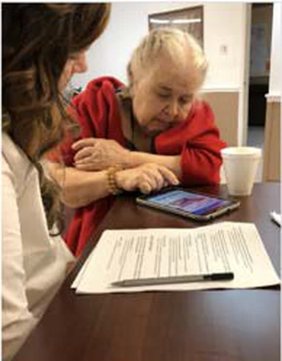 Research session with an older adult using a tablet application.