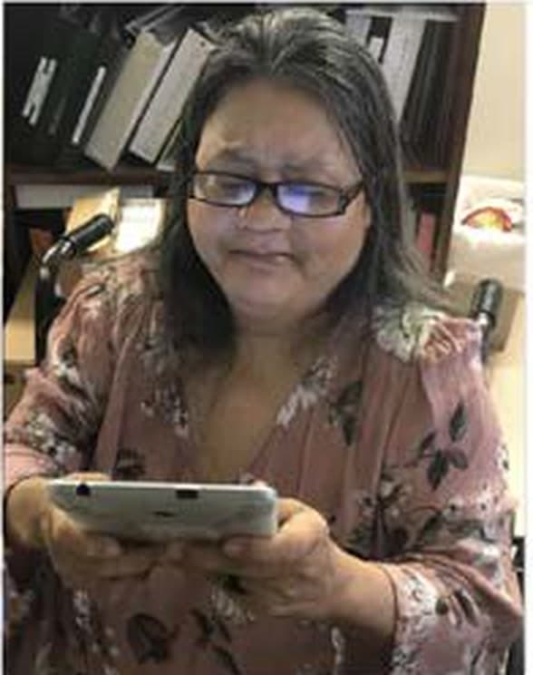 Older adult using a tablet during usability and accessibility testing.